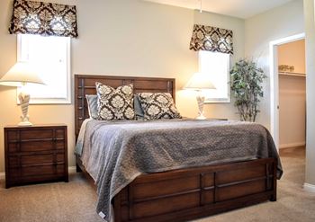 furnished bedroom with double windows